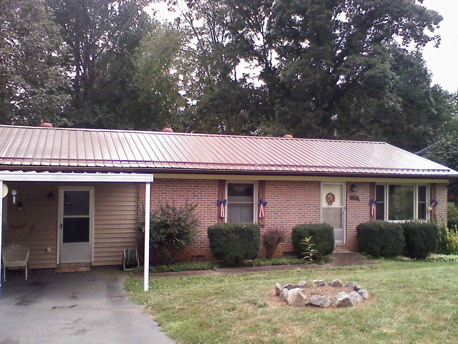 Bronze metal roof and carport on a brick ranch home — Roof Repair work by our crew in Great Valley
