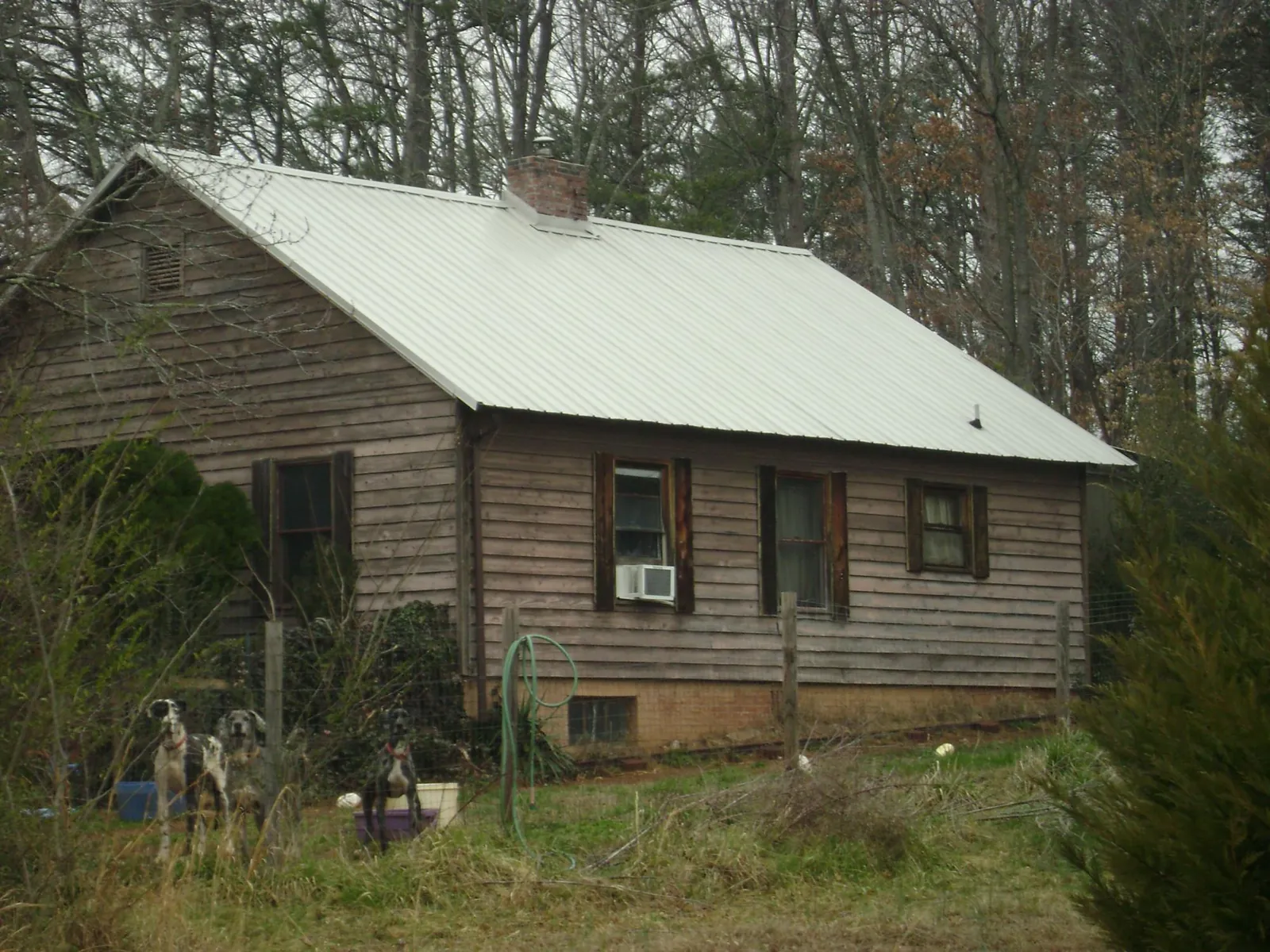 White metal roof on an old wood sided farmhouse, from a Metal Roof Installation job in Great Valley